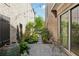 A patio with string lights and a water feature, framed by lush greenery between brick walls at 260 Jasmine Garden Way, Alpharetta, GA 30009