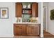 Elegant bar area with custom cabinetry, countertop, and decorative shelving at 260 Jasmine Garden Way, Alpharetta, GA 30009