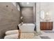 Lovely bathroom featuring a freestanding tub, wood-look shower, and modern vanity at 260 Jasmine Garden Way, Alpharetta, GA 30009