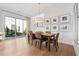 Bright dining room features a wooden table, pendant lighting, and sliding doors to the outside at 260 Jasmine Garden Way, Alpharetta, GA 30009