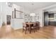 Dining room boasts wood floors, modern light fixture and staircase to the second floor at 260 Jasmine Garden Way, Alpharetta, GA 30009