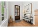 Stylish entryway with wood floors, a decorative console table, and natural light from a window at 260 Jasmine Garden Way, Alpharetta, GA 30009