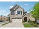 Charming two-story home with brick and siding, a well-manicured lawn, and an attached two-car garage at 260 Jasmine Garden Way, Alpharetta, GA 30009