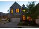 Inviting home exterior with warm, illuminated windows and a manicured front yard at 260 Jasmine Garden Way, Alpharetta, GA 30009