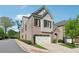 Well-manicured home with brick and siding, an attached two-car garage, and lush green trees at 260 Jasmine Garden Way, Alpharetta, GA 30009