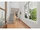 Inviting foyer with hardwood floors, a staircase, and a large window offering natural light at 260 Jasmine Garden Way, Alpharetta, GA 30009