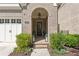 Charming front entrance with brick archway, elegant door, and manicured landscaping at 260 Jasmine Garden Way, Alpharetta, GA 30009