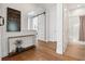 Hallway featuring wood floors, a decorative sliding door, and a view into a bright bathroom at 260 Jasmine Garden Way, Alpharetta, GA 30009