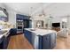 Open-concept kitchen with a large island, stainless steel appliances, and view to the living area at 260 Jasmine Garden Way, Alpharetta, GA 30009