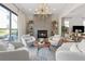 Living room with fireplace, tile surround, modern chandelier and access to patio at 260 Jasmine Garden Way, Alpharetta, GA 30009