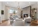 Cozy living room with a fireplace, modern light fixture, and access to a patio at 260 Jasmine Garden Way, Alpharetta, GA 30009