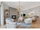 Open-concept living room with a cozy fireplace, stylish chandelier, and comfortable seating at 260 Jasmine Garden Way, Alpharetta, GA 30009