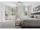 Bright main bedroom with a large bed, neutral tones, an area rug, and natural light from two windows at 260 Jasmine Garden Way, Alpharetta, GA 30009