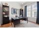 Home office with a black desk, bookshelves, a ceiling fan, and natural light from the window at 260 Jasmine Garden Way, Alpharetta, GA 30009