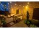 Outdoor patio with fire pit, seating, dining table, and lush potted plants at 260 Jasmine Garden Way, Alpharetta, GA 30009