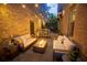 Cozy patio with comfortable seating, a modern fire pit, and ambient string lighting at 260 Jasmine Garden Way, Alpharetta, GA 30009