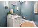 Stylish powder room featuring a modern vanity, granite countertop, and blue walls at 260 Jasmine Garden Way, Alpharetta, GA 30009