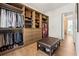 Well-organized walk-in closet with custom shelving, drawers, and a convenient bench at 260 Jasmine Garden Way, Alpharetta, GA 30009