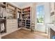 Spacious walk-in closet with custom shelving and a large window offering natural light at 260 Jasmine Garden Way, Alpharetta, GA 30009