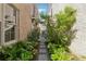 Stone walkway with greenery between brick buildings, leading to outdoor area at 260 Jasmine Garden Way, Alpharetta, GA 30009