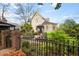 Backyard featuring a brick-lined fence with a well-manicured garden, and view of the home's architecture at 511 Sycamore St, Decatur, GA 30030