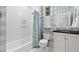 Charming bathroom with a tub and shower combination and classic fixtures with stylish patterned wallpaper at 511 Sycamore St, Decatur, GA 30030