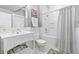 Bright bathroom featuring white subway tiles, classic fixtures, and a combined tub and shower at 511 Sycamore St, Decatur, GA 30030