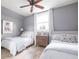 Serene bedroom featuring two twin beds, neutral tones, and soft textures, creating a calm and inviting atmosphere at 511 Sycamore St, Decatur, GA 30030