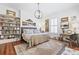 Cozy bedroom with a large bed, artwork, wood floors, and stylish furniture at 511 Sycamore St, Decatur, GA 30030