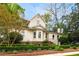 Charming two-story home with landscaped yard featuring manicured hedges and lush green trees on a beautiful lot at 511 Sycamore St, Decatur, GA 30030