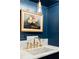 Elegant hallway featuring navy blue cabinetry with gold hardware and a marble countertop with a vintage light fixture at 511 Sycamore St, Decatur, GA 30030