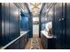 Elegant hallway featuring navy blue cabinetry with gold hardware and a marble countertop with a geometric light fixture at 511 Sycamore St, Decatur, GA 30030