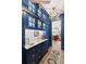 Elegant hallway featuring navy blue cabinetry with gold hardware and a marble countertop with a beautiful light fixture at 511 Sycamore St, Decatur, GA 30030