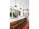 Modern kitchen featuring a large island with a marble countertop, wood accents, and stylish pendant lighting above at 511 Sycamore St, Decatur, GA 30030