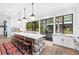 Bright kitchen featuring a large island with a marble countertop, wood accents, and stainless steel appliances at 511 Sycamore St, Decatur, GA 30030