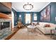 Bright living room featuring a fireplace, neutral sofa, and a large painting over the sofa at 511 Sycamore St, Decatur, GA 30030