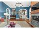 Spacious living room with fireplace, blue walls, arched entries, and stylish furnishings and decor at 511 Sycamore St, Decatur, GA 30030