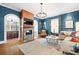 Inviting living room with fireplace, blue walls, hardwood floors, and cozy seating area at 511 Sycamore St, Decatur, GA 30030