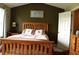 Bedroom with wooden bed frame, matching nightstand and dresser, and neutral carpet at 1920 Stancrest Nw Trce, Kennesaw, GA 30152