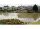 Scenic view of townhouses overlooking a tranquil pond with a fountain feature at 1920 Stancrest Nw Trce, Kennesaw, GA 30152