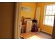 Room with light wood floors, yellow walls, and various items including luggage at 1920 Stancrest Nw Trce, Kennesaw, GA 30152
