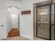 Bathroom featuring a glass enclosed shower and tile surround in addition to an arched entrance to the hall at 201 Hunley Ct, Alpharetta, GA 30005