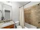 Bathroom featuring tiled shower and tub, granite counters, and sink at 201 Hunley Ct, Alpharetta, GA 30005