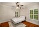 This bedroom has hardwood floors, a ceiling fan, great natural light, and neutral colors at 201 Hunley Ct, Alpharetta, GA 30005