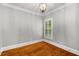 Cozy bedroom features hardwood floors, neutral paint, and natural light at 201 Hunley Ct, Alpharetta, GA 30005