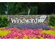 Stone entrance to Windward, surrounded by colorful flowers and manicured landscaping at 201 Hunley Ct, Alpharetta, GA 30005