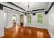 Dining room featuring dark trim, hardwood floors, decorative wall paneling and view to office at 201 Hunley Ct, Alpharetta, GA 30005