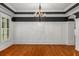 Elegant dining room featuring dark trim, hardwood floors, and decorative wall paneling at 201 Hunley Ct, Alpharetta, GA 30005