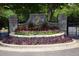 Stone entrance featuring a landscaped flower bed and a gold insignia at 201 Hunley Ct, Alpharetta, GA 30005