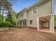 The back exterior of the house features a brick patio and lots of windows for tons of natural light at 201 Hunley Ct, Alpharetta, GA 30005